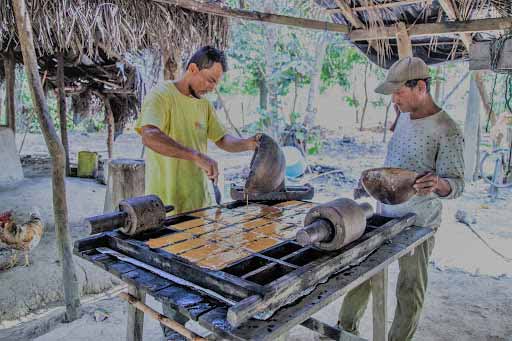 A photo of two men baking a Colombian snack