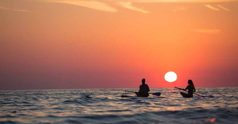 Couple kayaking during sunset